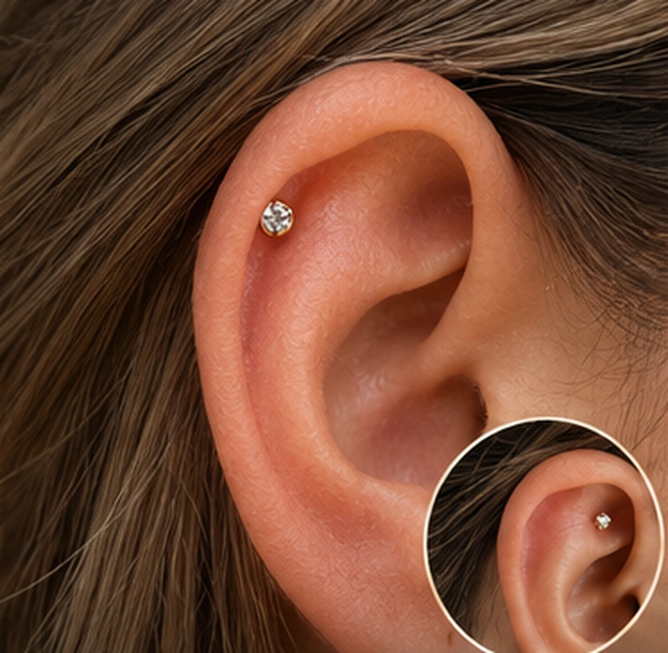 Referencia visual de piercing hélix en la oreja